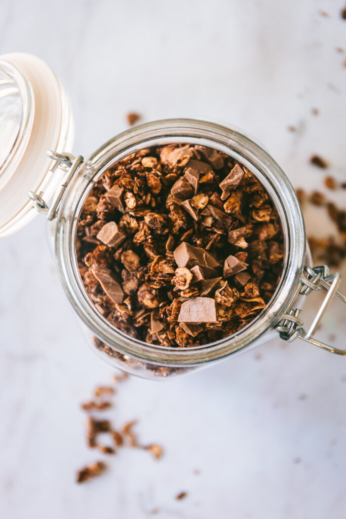 overhead of Chocolate Hazelnut Dessert Granola in a mason jar