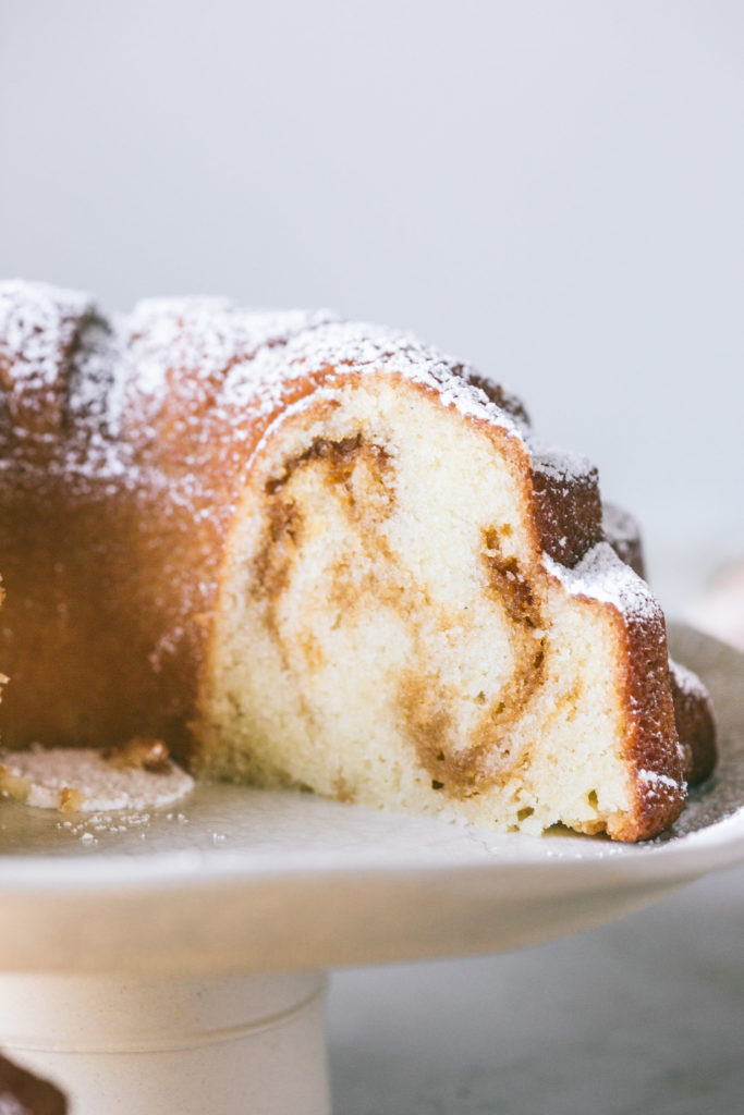 Salted Caramel Bundt Cake with a slice of cake taken out to reveal salted caramel ribboned through out the inside of the cake