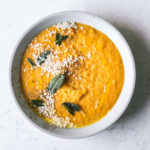 overhead image of Butternut Squash Soup with Crispy Sage spinkled with toasted sesame seeds