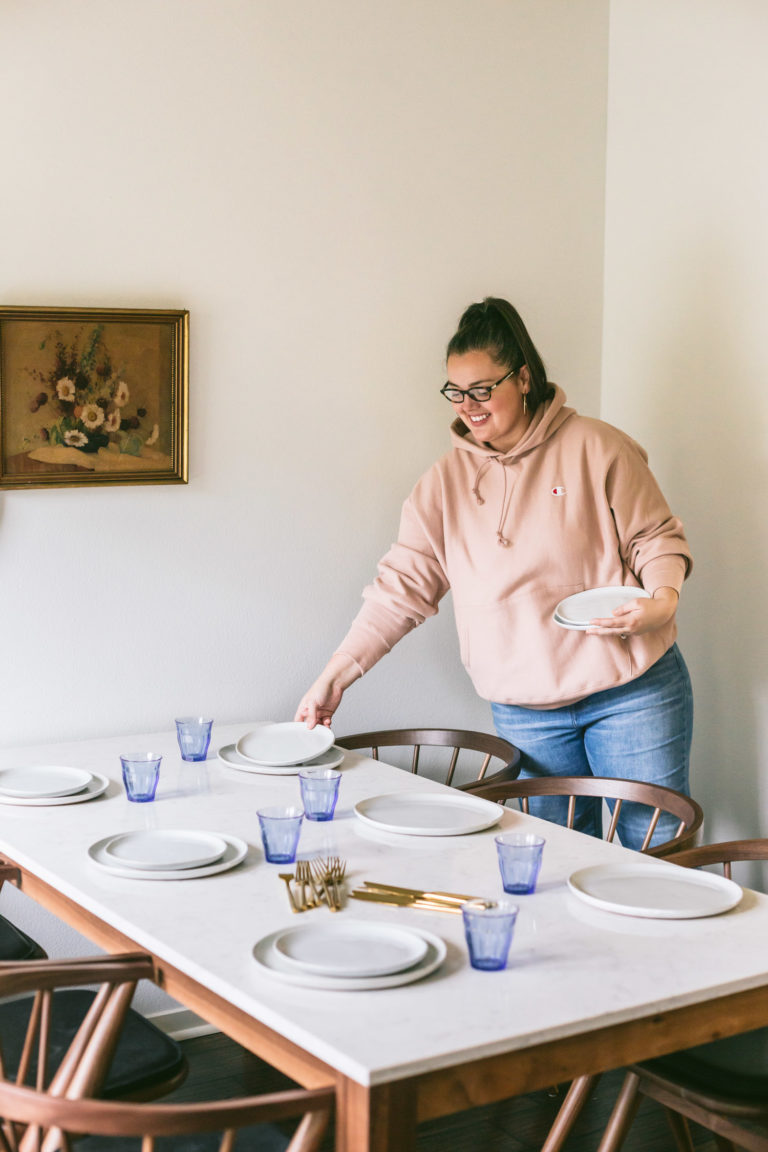 Karlee is putting place settings on her brand new table