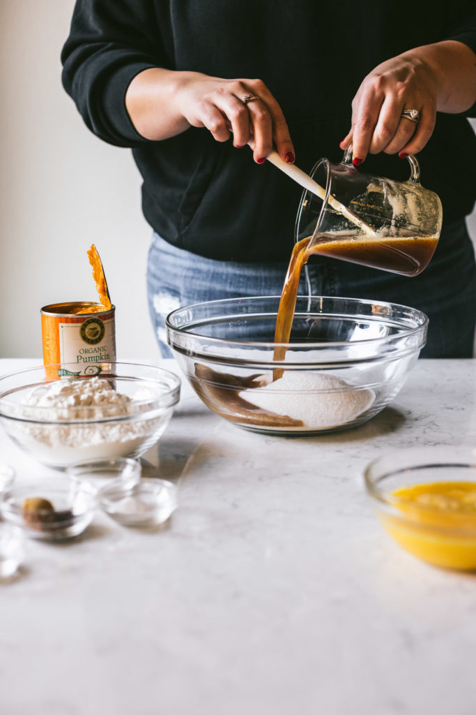 head on image of Karlee pouring browned butter into a glass bowl Bars with Browned Butter Cream Cheese Frosting