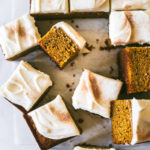 Pumpkin Bars with Browned Butter Cream Cheese Frosting sprinkled with cinnamon and sugar and cut into squares