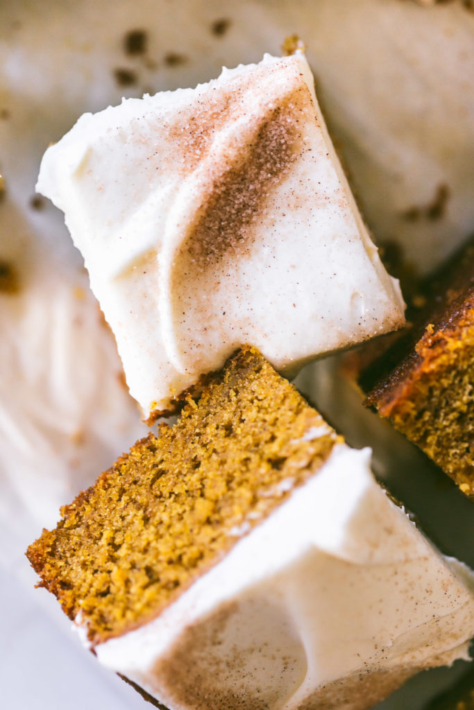 Close up of Pumpkin Bars with Browned Butter Cream Cheese Frosting sprinkled with cinnamon and sugar