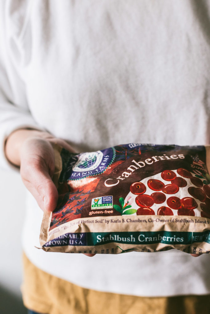 Karlee holding a Stahlbush frozen Cranberry bag