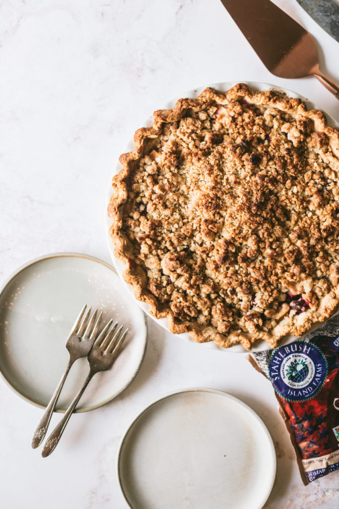 Baked cranapple pie with plates, ready to serve