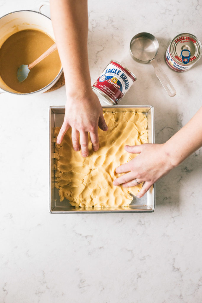 overhead shot of the crust being pressed into the pan