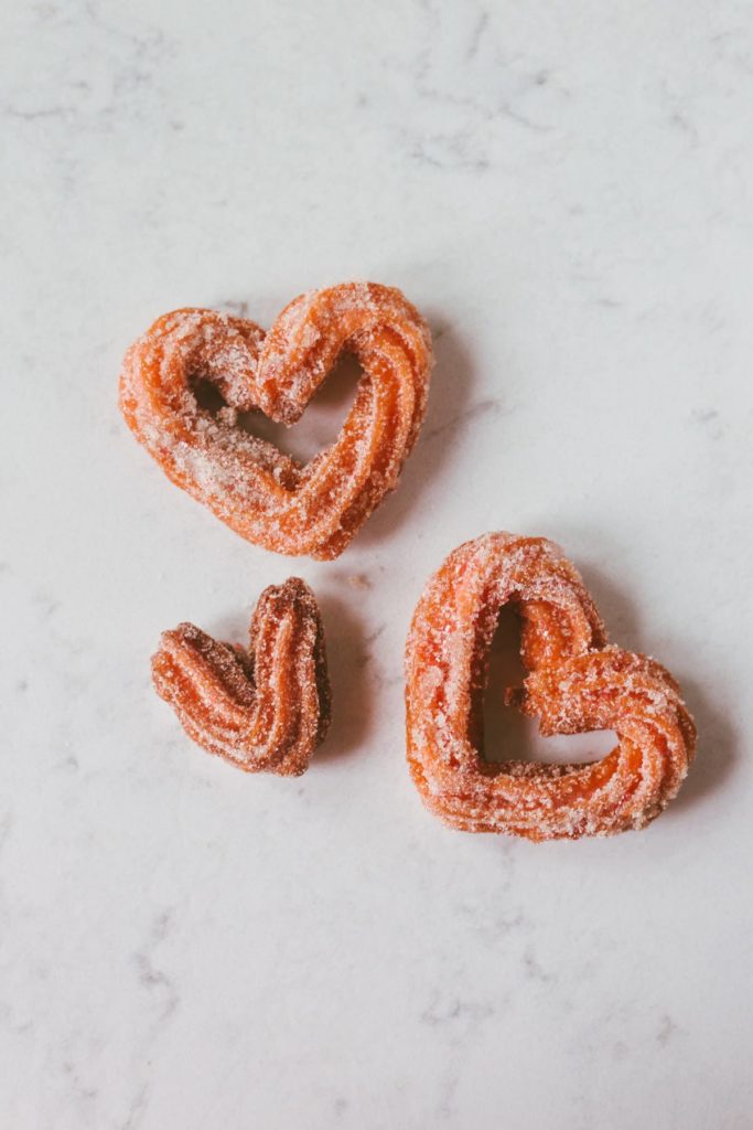 Over head shot of three heart-shaped churros