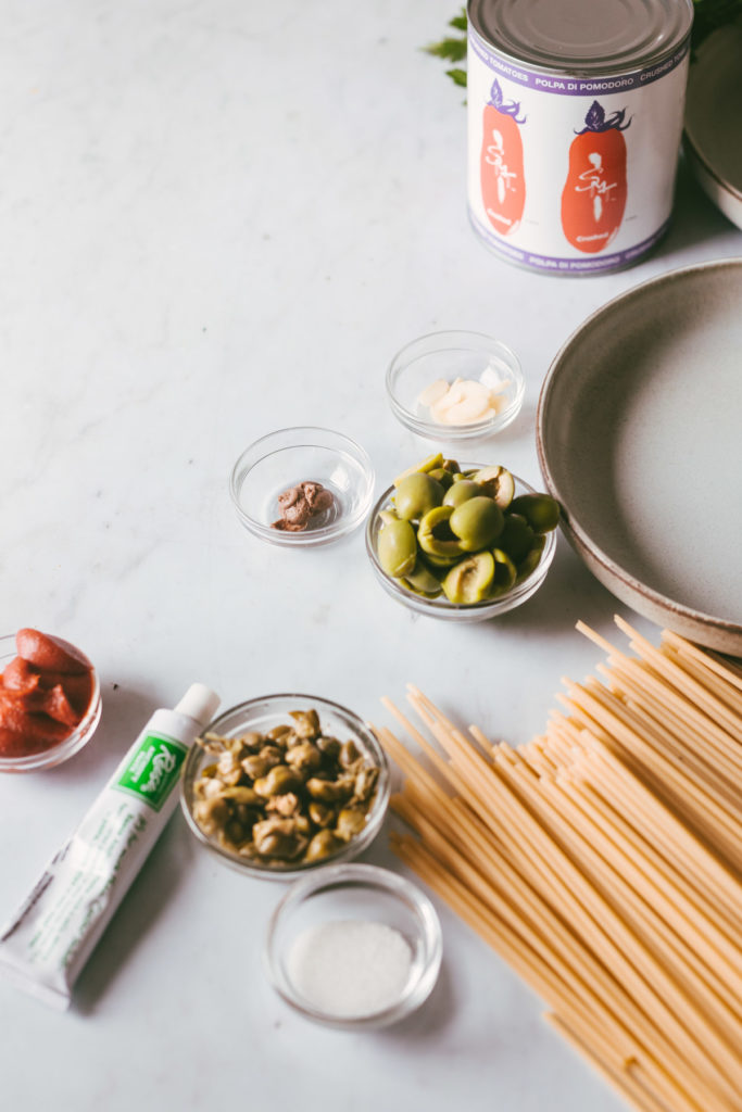 mise en place Past in puttanesca sauce: bucatini, canned tomatoes, olives, capers, tomato paste, anchovy paste, sugar, garlic 