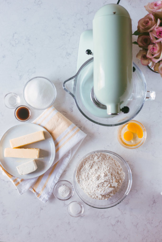 overhead image of cookie dough ingredients next to a pistachio kitchen aid mixer