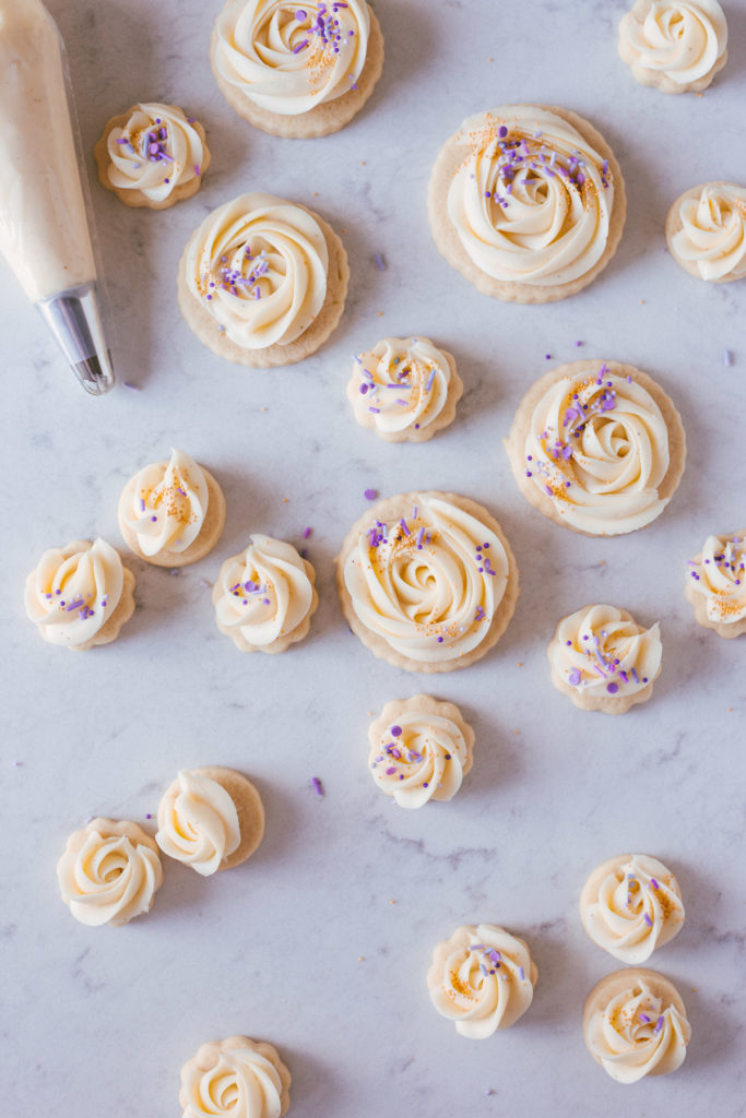 Finished cookies with buttercream swirled on the tops and purple sprinkles