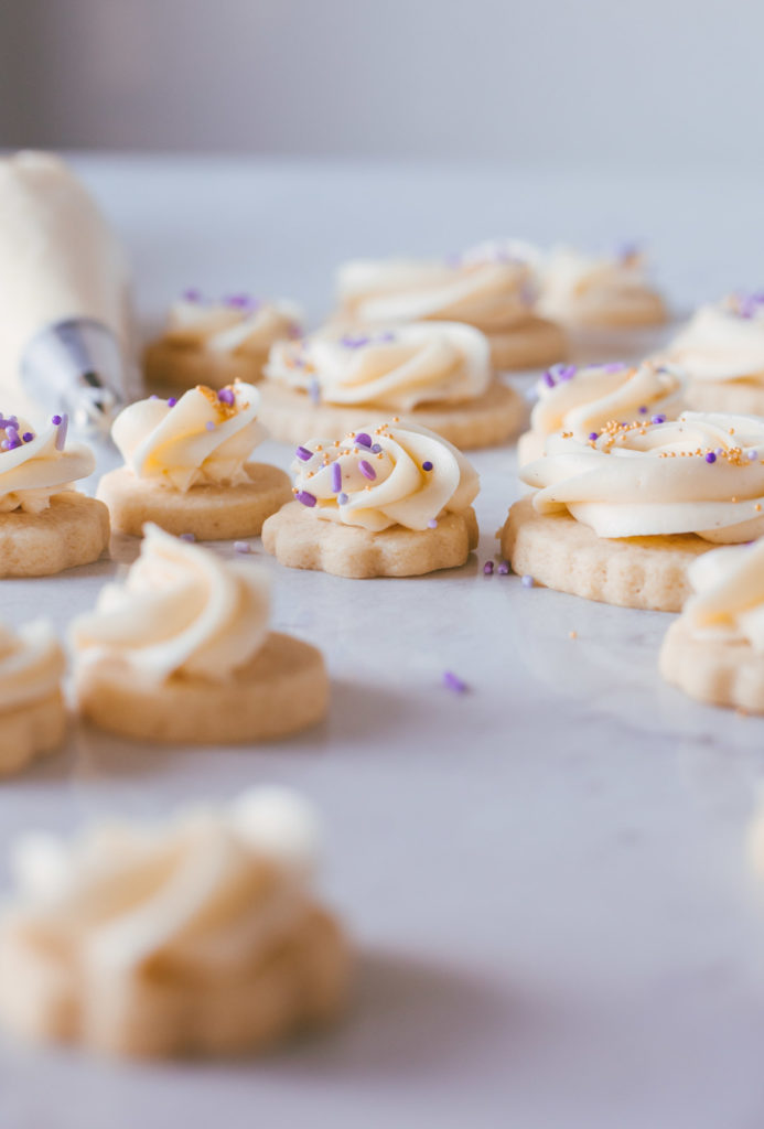 Finished cookies with buttercream swirled on the tops and purple sprinkles