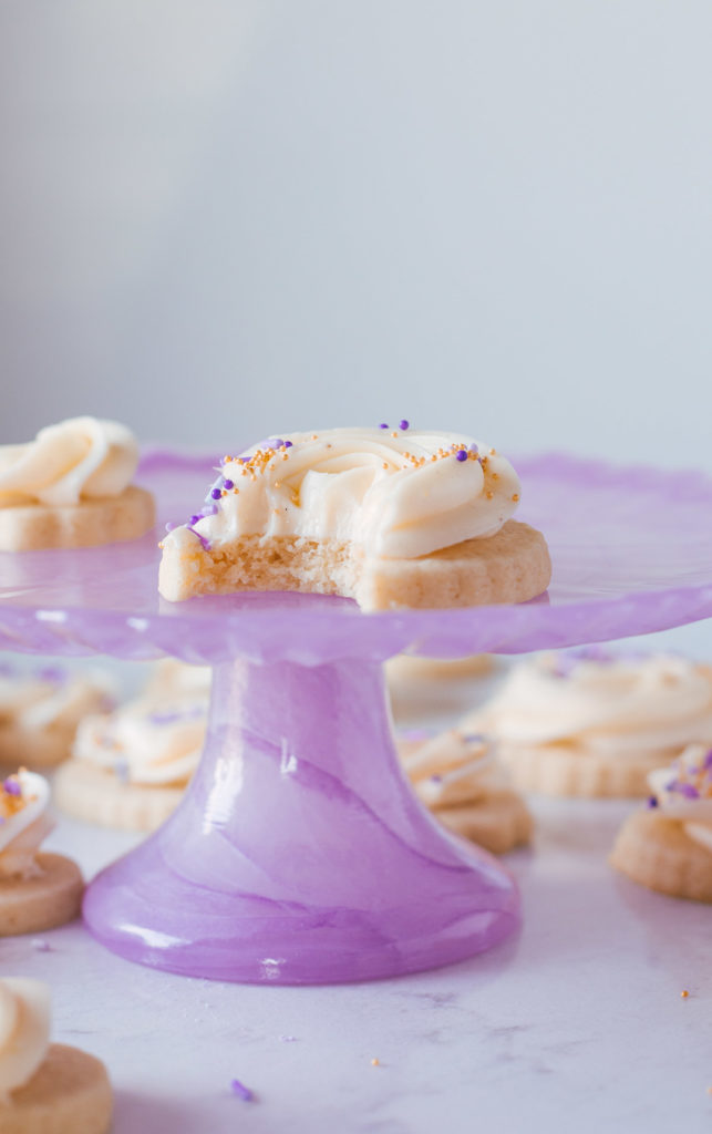 Finished cookies with buttercream swirled on the tops and purple sprinkles