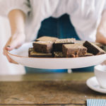 Holding a plate of brownie squares