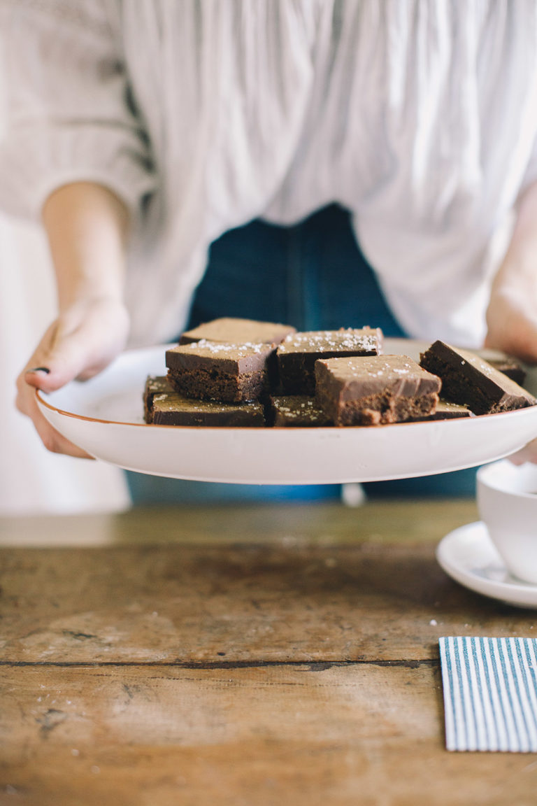 Holding a plate of brownie squares