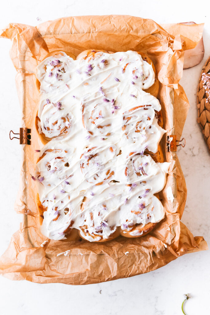 Overhead image of finished rolls with cream cheese slathered on top