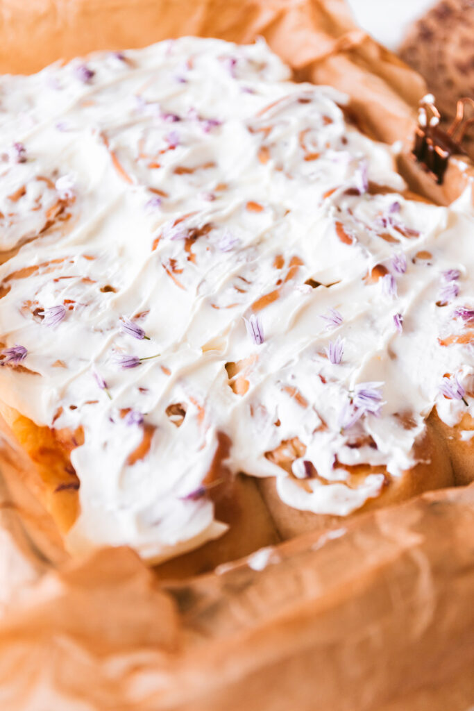 angled image of finished rolls with cream cheese slathered on top