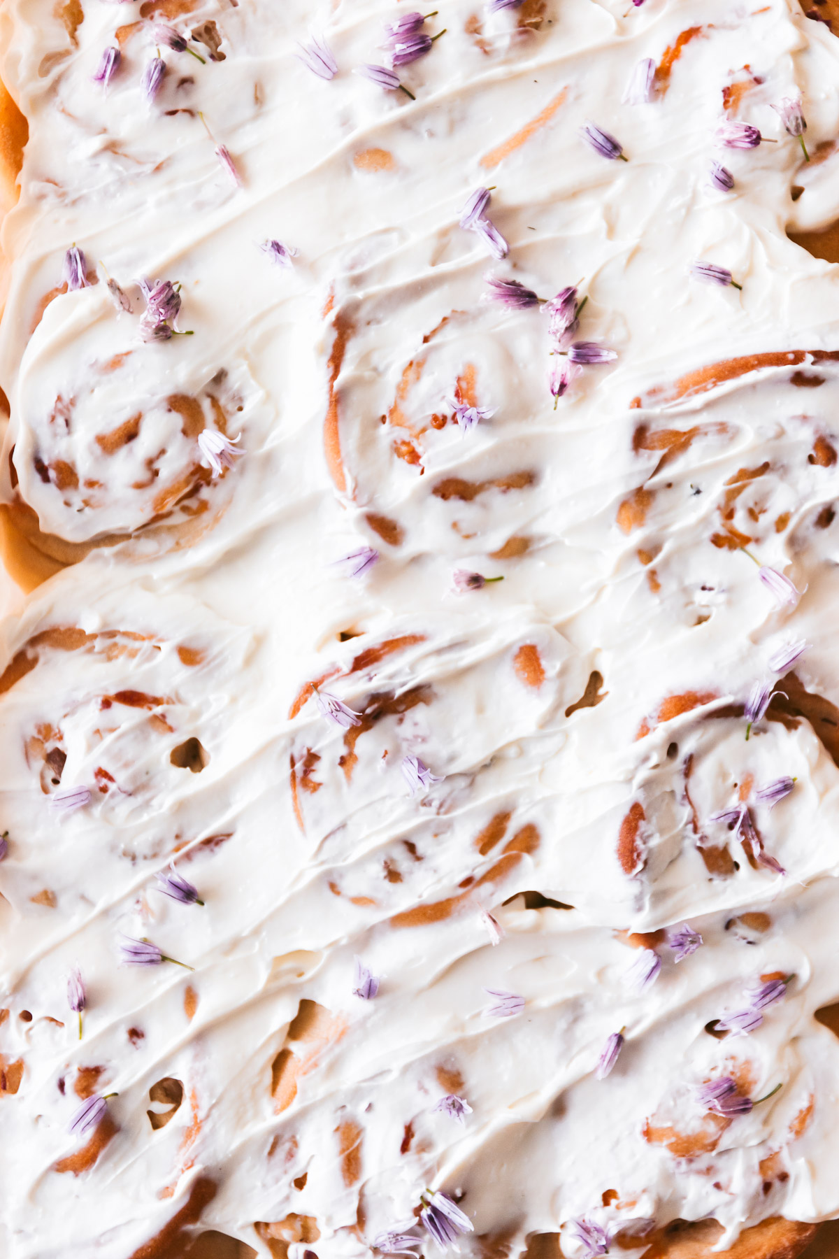 Overhead image of finished rolls with cream cheese slathered on top