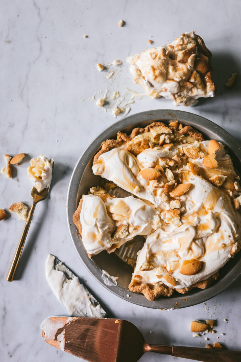 Overhead image of finished pie with several slices being taken and a mess around the pie plate