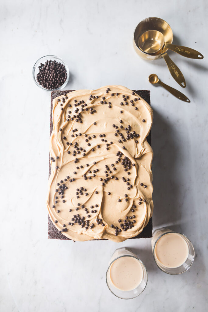 A chocolate sheet cake with peanut butter frosting topped with chocolate crunch balls