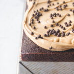 A chocolate sheet cake with peanut butter frosting topped with chocolate crunch balls