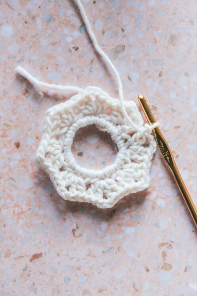 one single white knit scrunchie about to be finished