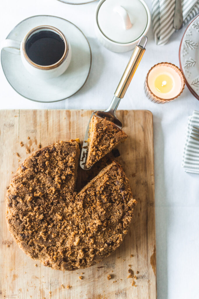 Overhead shot of the whole completed coffee cake with a slice slightly removed