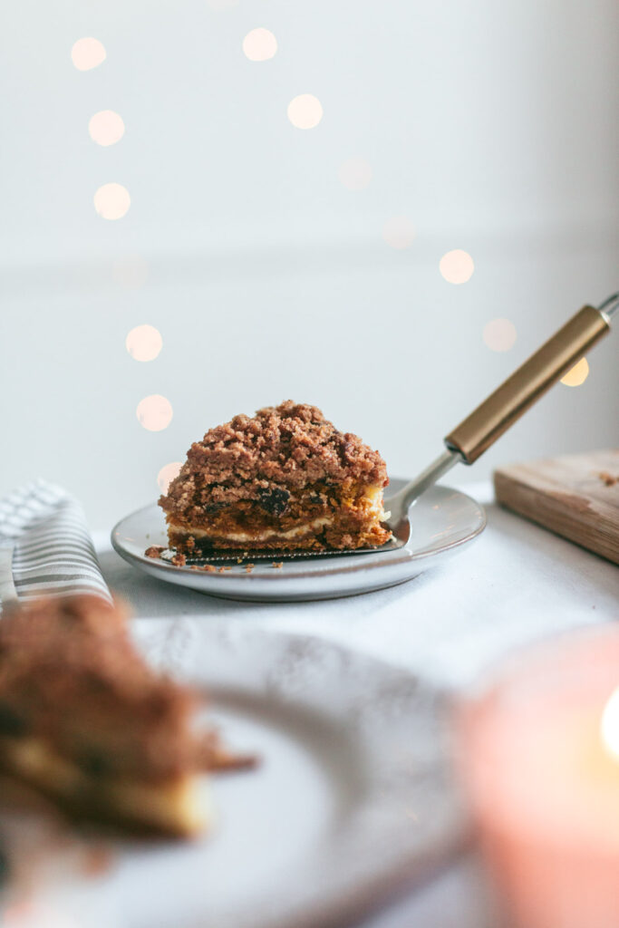 A slice of Chocolate Chip Pumpkin Coffee Cake with Cream Cheese Filling revealing the inside