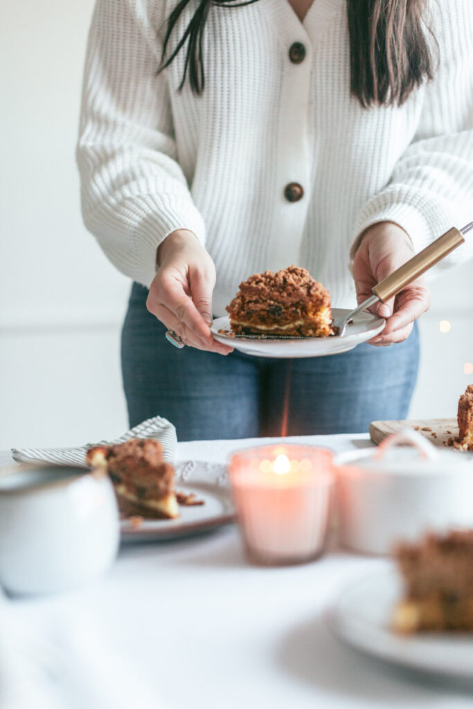 a person holding a Chocolate Chip Pumpkin Coffee Cake with Cream Cheese Filling