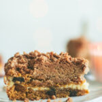 A slice of Chocolate Chip Pumpkin Coffee Cake with Cream Cheese Filling revealing the inside
