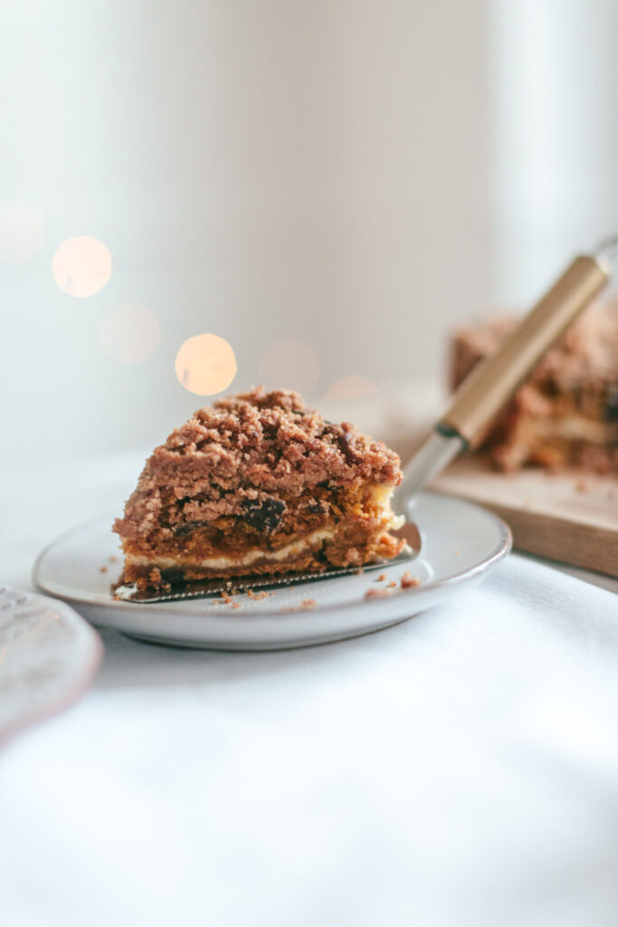 A slice of Chocolate Chip Pumpkin Coffee Cake with Cream Cheese Filling revealing the inside