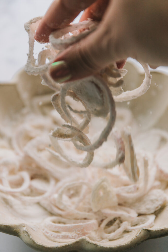 tossing shallots in batter